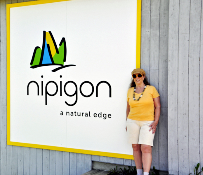 Karen Duquette at the Nipigon sign